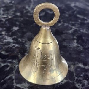 Vintage Solid brass Bell and features an engraved or etched unicorn design. 